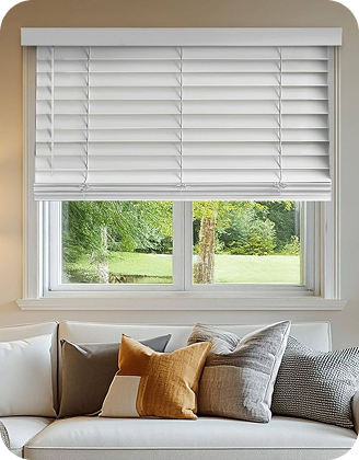 White horizontal blinds installed above a living room sofa