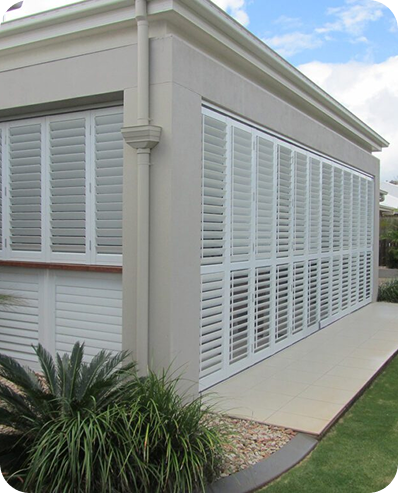 White shutters enclosing a covered residential patio