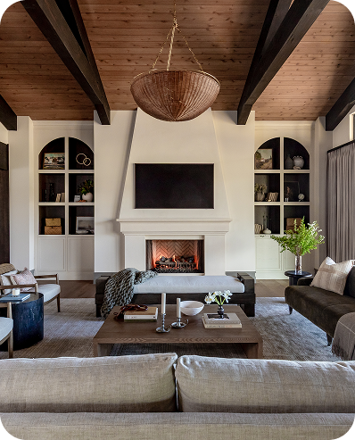 Floor-length drapery framing a living room fireplace and windows