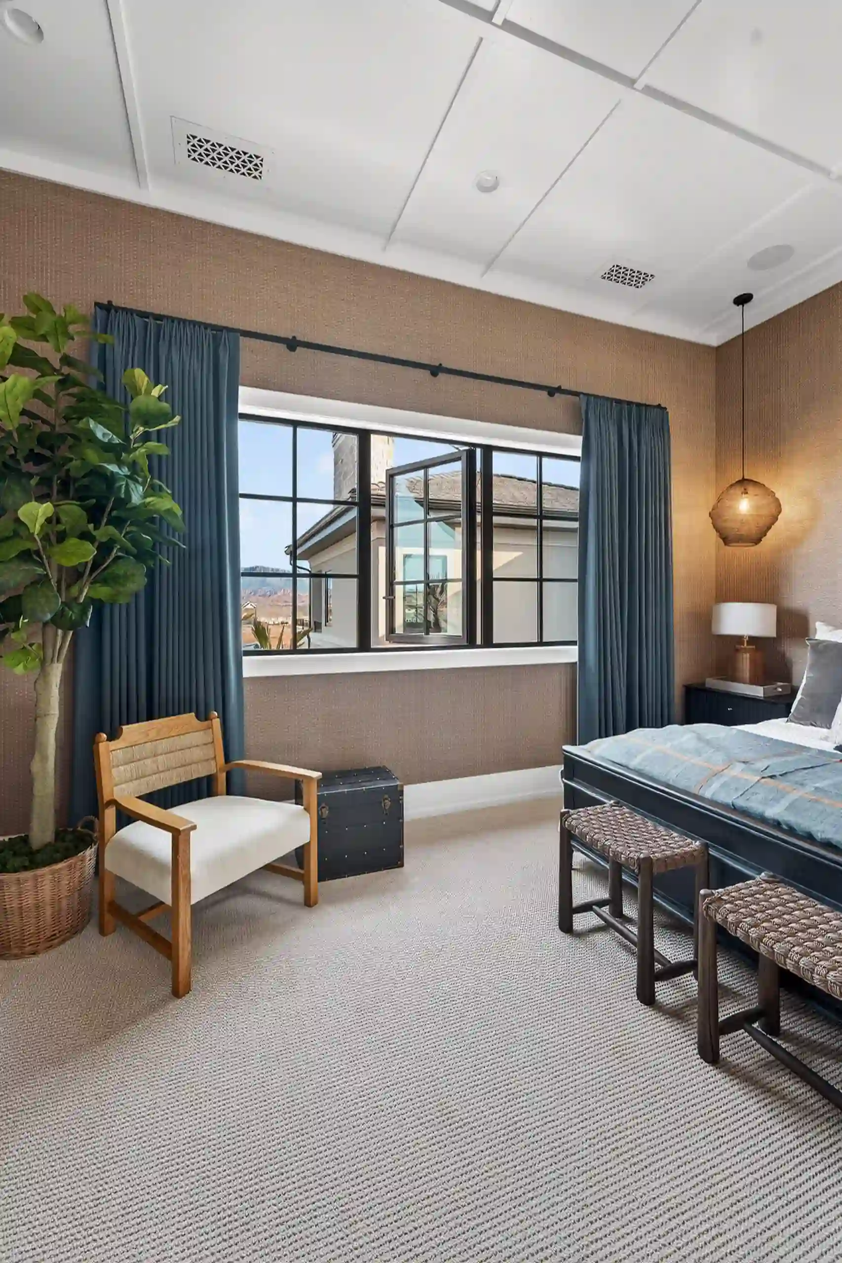Bedroom sliding doors framed by neutral drapery